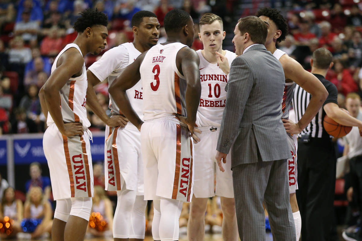 UNLV Rebels head coach T. J. Otzelberger talks to his team during a time out in the second half ...