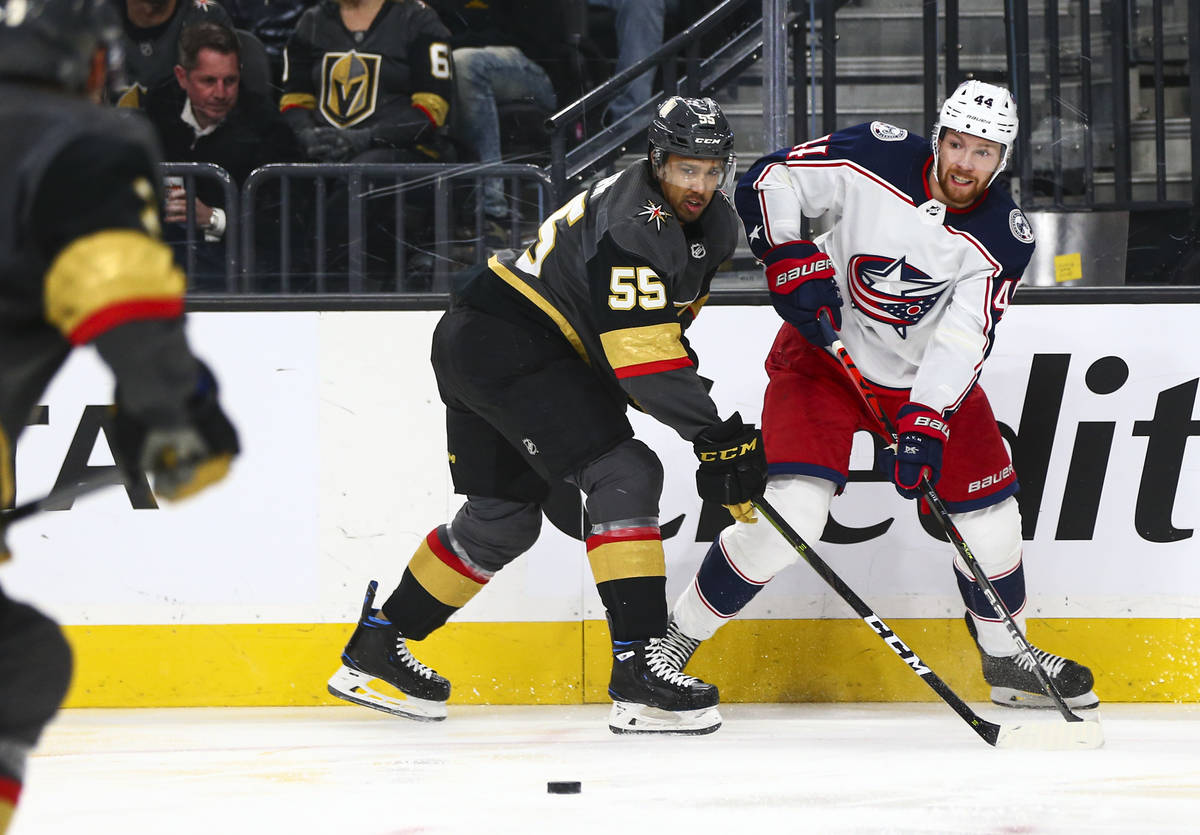 Columbus Blue Jackets' Vladislav Gavrikov (44) sends the puck past Golden Knights' Keegan Koles ...