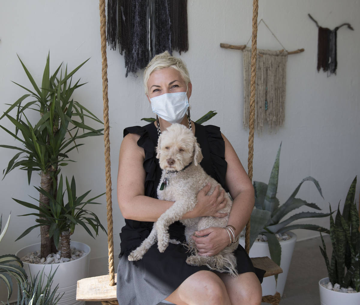 Megan Linney poses for a photo with her dog, Bowie, at her downtown Las Vegas skin care salon, ...