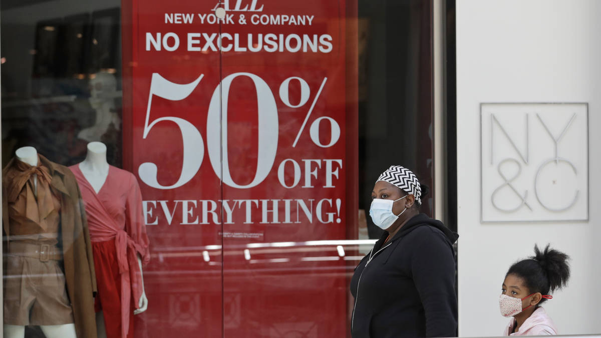 A woman walks with a child at SouthPark Mall, Wednesday, May 13, 2020, in Strongsville, Ohio. O ...