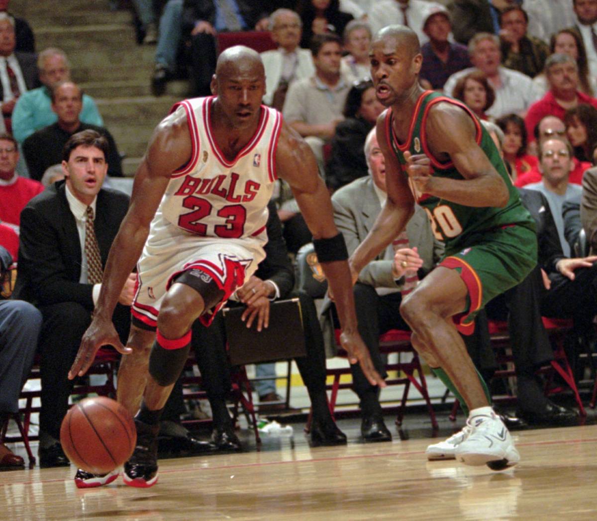 Chicago Bulls' Michael Jordan drives around Seattle SuperSonics' Gary Payton during Game 1 of t ...