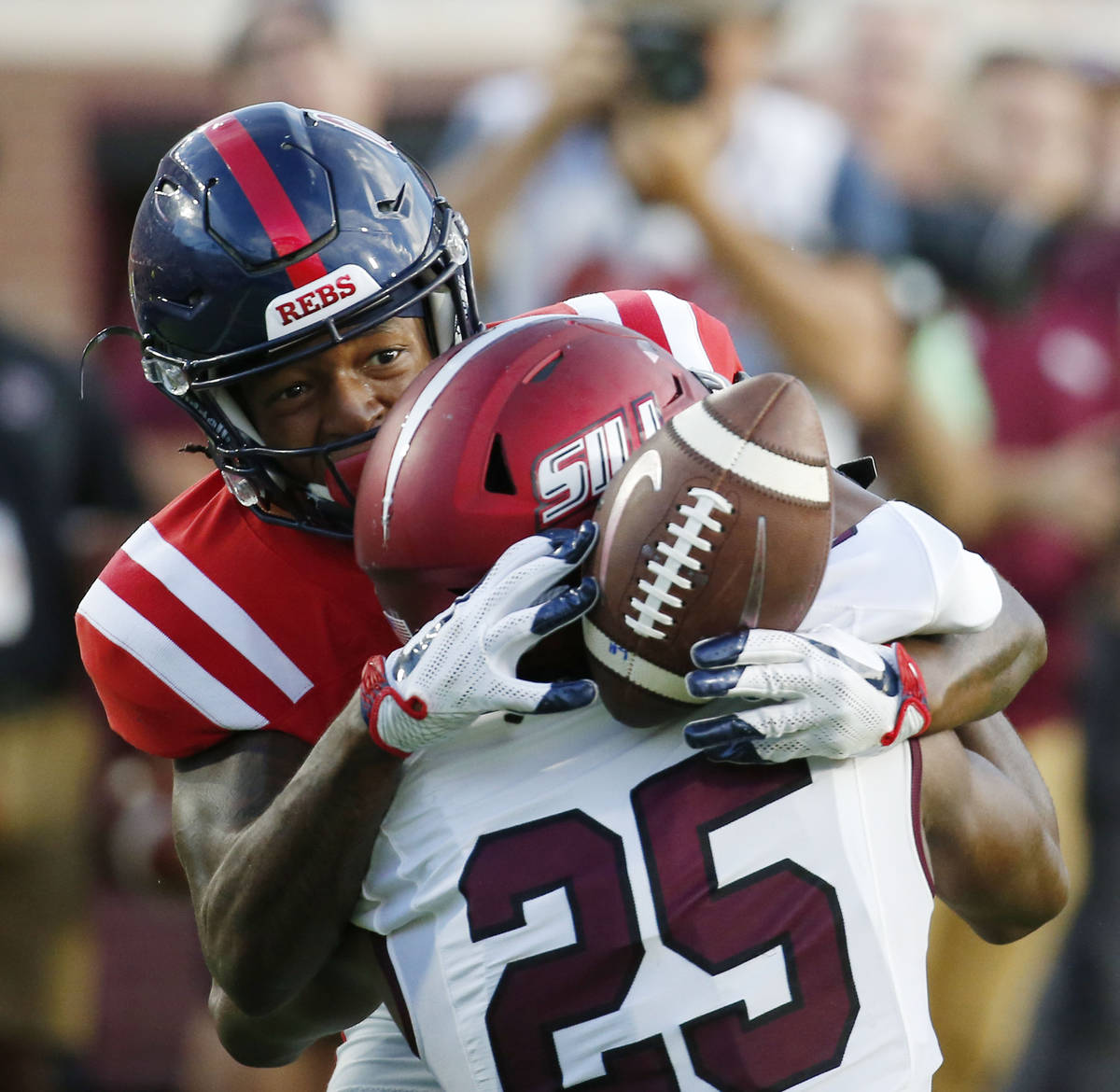 Mississippi wide receiver Alex Weber (85) reaches around Southern Illinois cornerback Madre Har ...