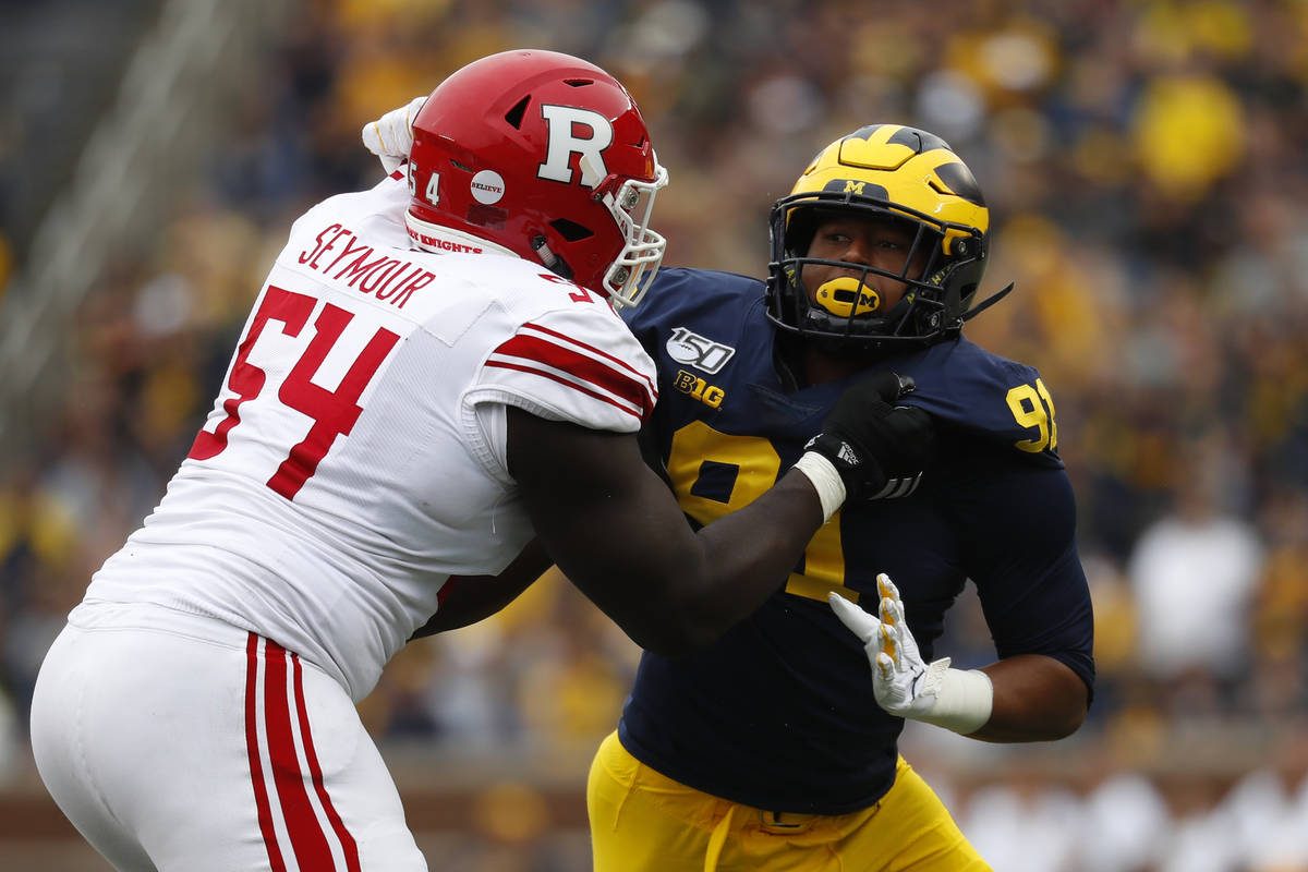 Michigan defensive lineman Taylor Upshaw (91) rushes against Rutgers offensive lineman Kamaal S ...