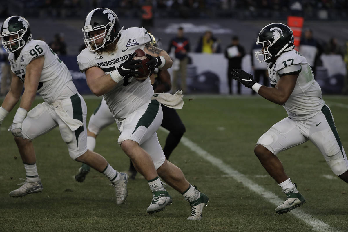 Michigan State's Mike Panasiuk (72) runs back an interception for a touchdown during the first ...