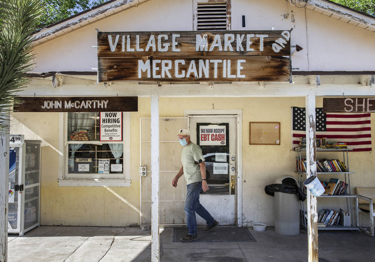 A customer wearing a medical mask walks out of Village Market and Mercantile in Blue Diamond on ...