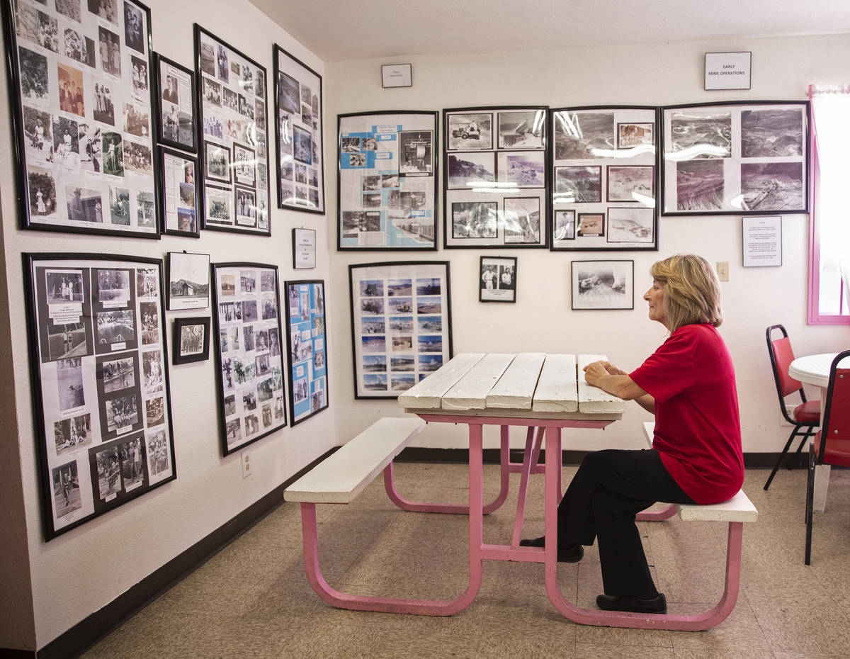 Store clerk Michele Schaffer looks at a room full of photos and documents she helped collect ch ...