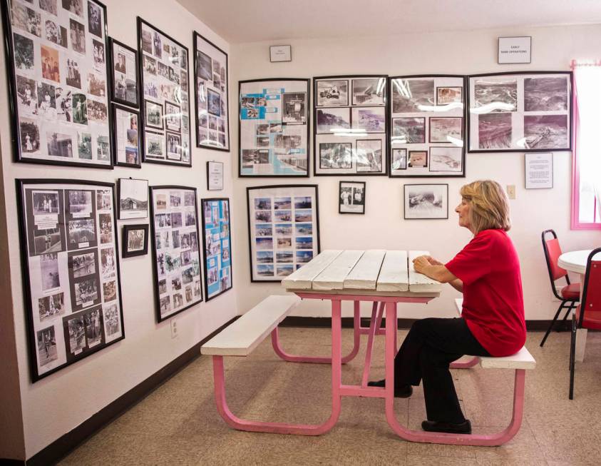 Store clerk Michele Schaffer looks at a room full of photos and documents she helped collect ch ...