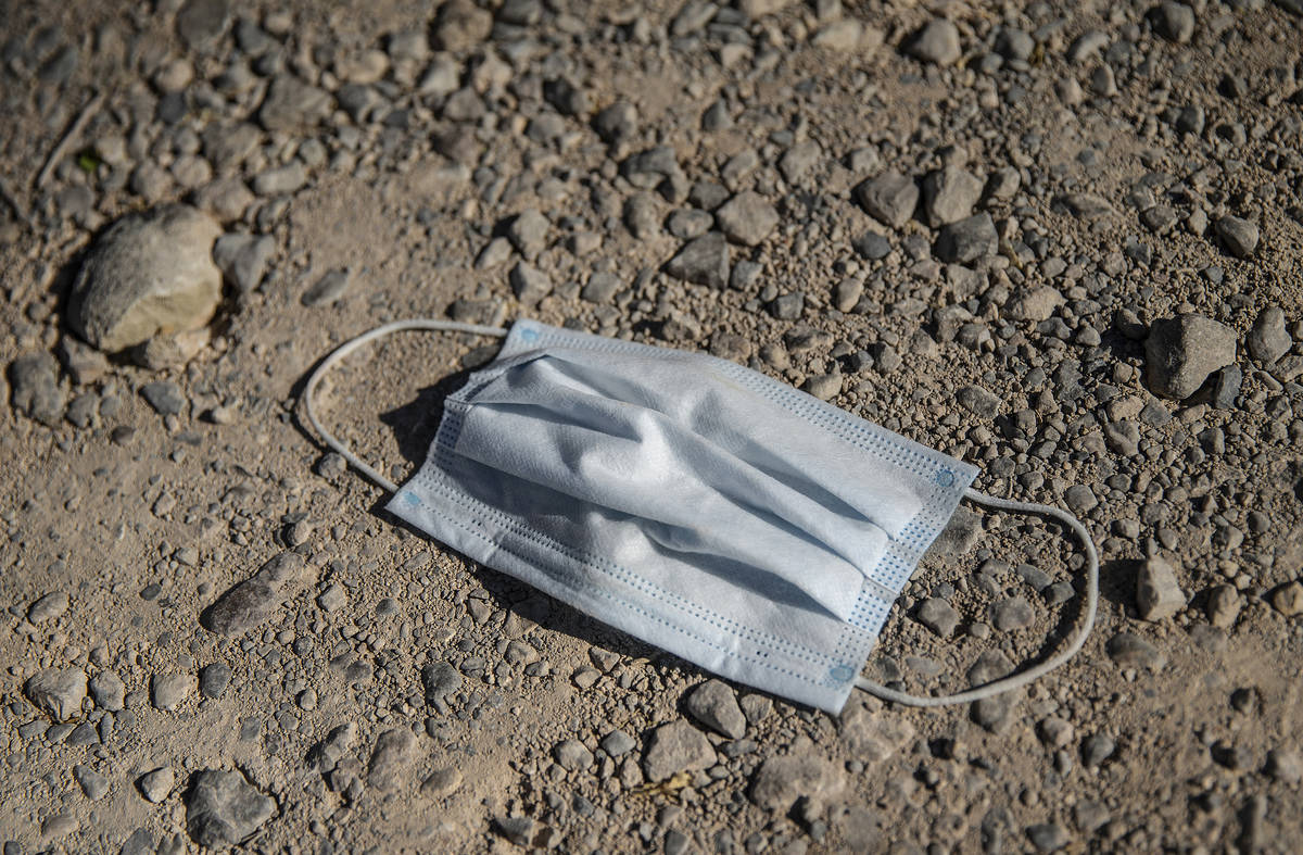 A discarded medical mask outside Village Market Mercantile in Blue Diamond on Wednesday, May 13 ...