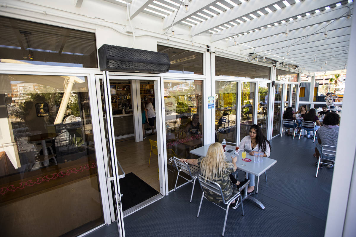 People dine at Downtown Terrace at Downtown Container Park on the first day of its reopening in ...