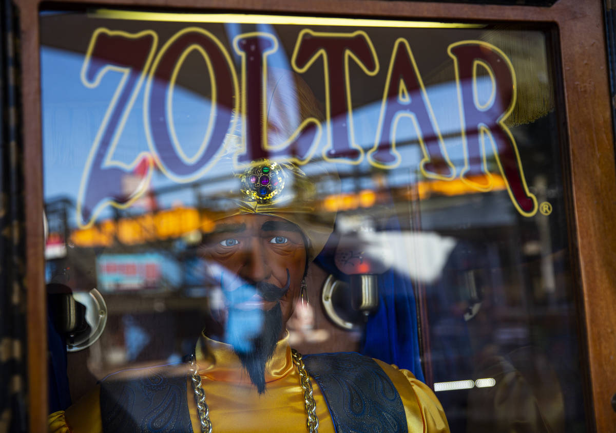 A Zoltar fortune telling machine outside of the Las Vegas Magic Shop reflects the Downtown Cont ...
