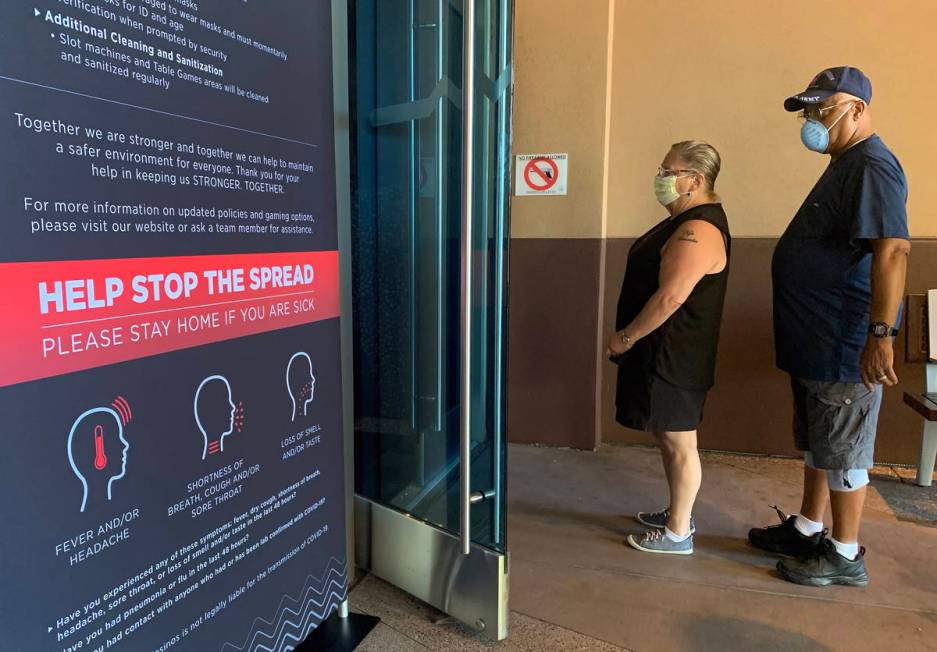 Individuals enter Gila River Casino at the Wild Horse Pass location on the packed reopening day ...