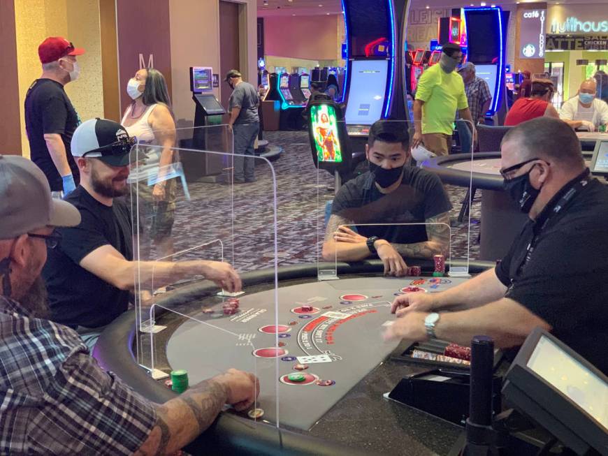 Individuals play table games at Gila River Casino's Lone Butte location on the packed reopening ...