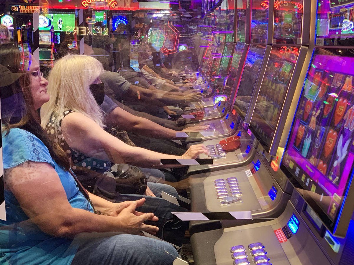 Plexiglass shields players as they gamble at Gila River Casino's Lone Butte location on the pac ...