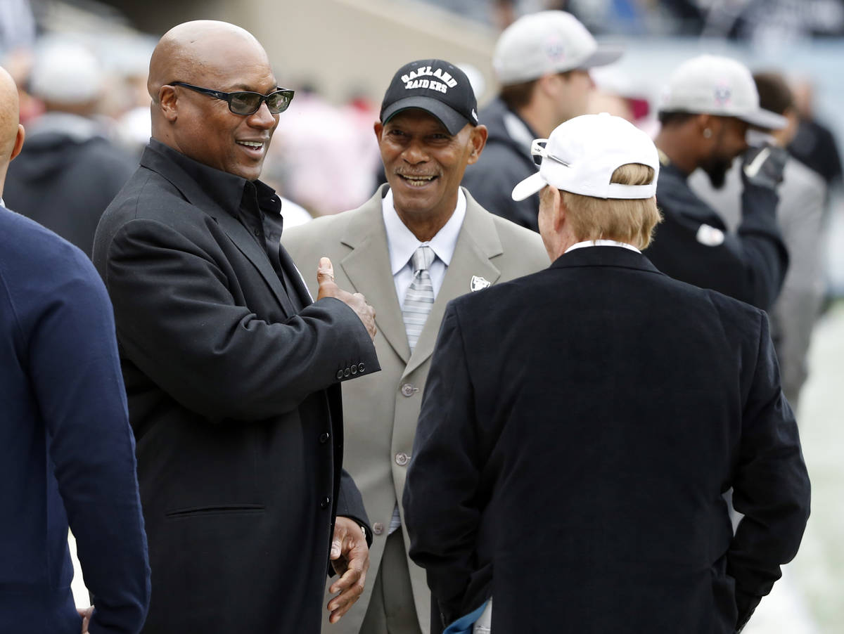 Former NFL players Bo Jackson, left, and Willie Brown talks to Oakland Raiders owner Mark Davis ...