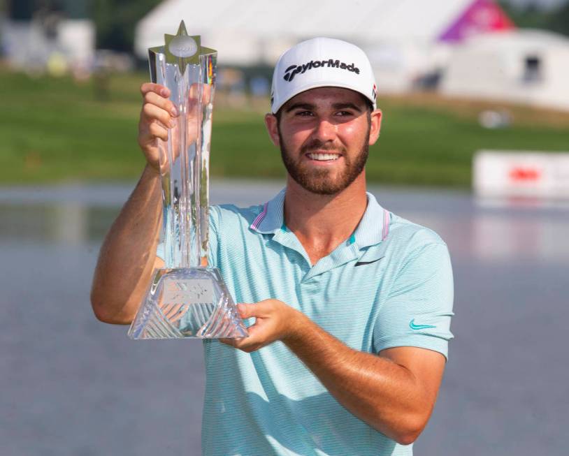 Matthew Wolff holds the trophy after winning the 3M Open golf tournament Sunday, July 7, 2019, ...