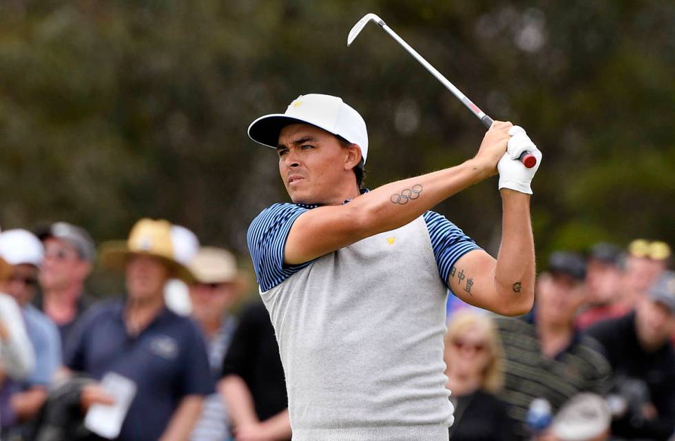 U.S. team player Rickie Fowler plays shot on the 16th hole in their foursomes match during the ...