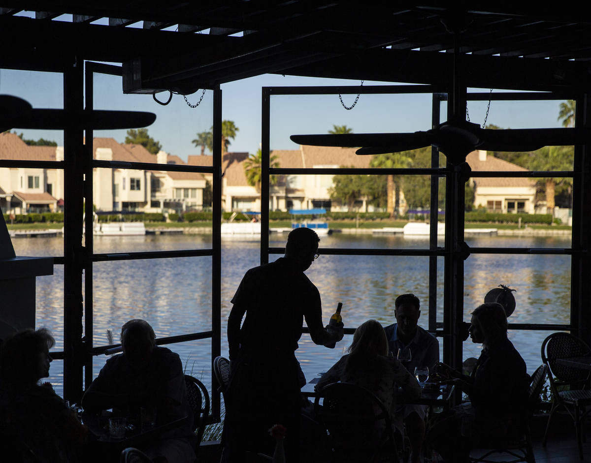 Diners enjoy a meal on the patio at Marché Bacchus on Friday, May 15, 2020, in Las Vegas. ...