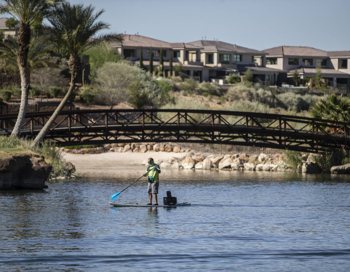 A paddle boarder passes under a bridge at Lake Las Vegas on Friday, May 15, 2020, in Henderson. ...