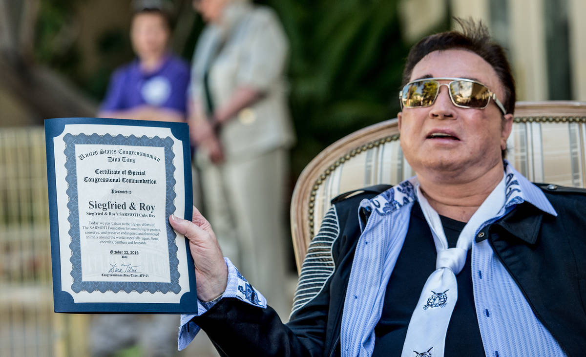 Roy Horn is shown with a proclamation from Rep. Dina Titus during a special appearance in celeb ...