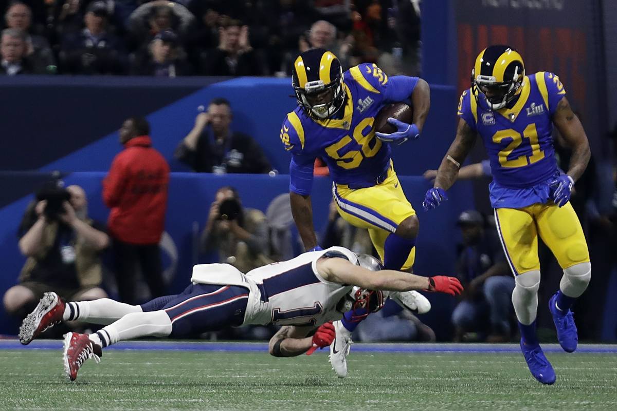 Los Angeles Rams' Cory Littleton (58) intercepts a pass as New England Patriots' Julian Edelman ...