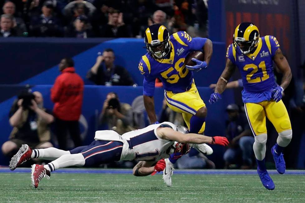 Los Angeles Rams' Cory Littleton (58) intercepts a pass as New England Patriots' Julian Edelman ...