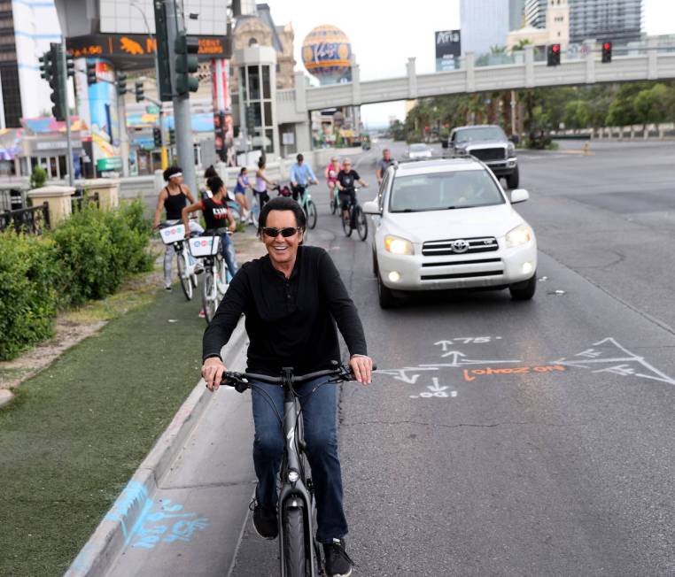 Mr. Las Vegas Wayne Newton rides a bicycle on the Strip in Las Vegas Saturday, May 16, 2020. (K ...