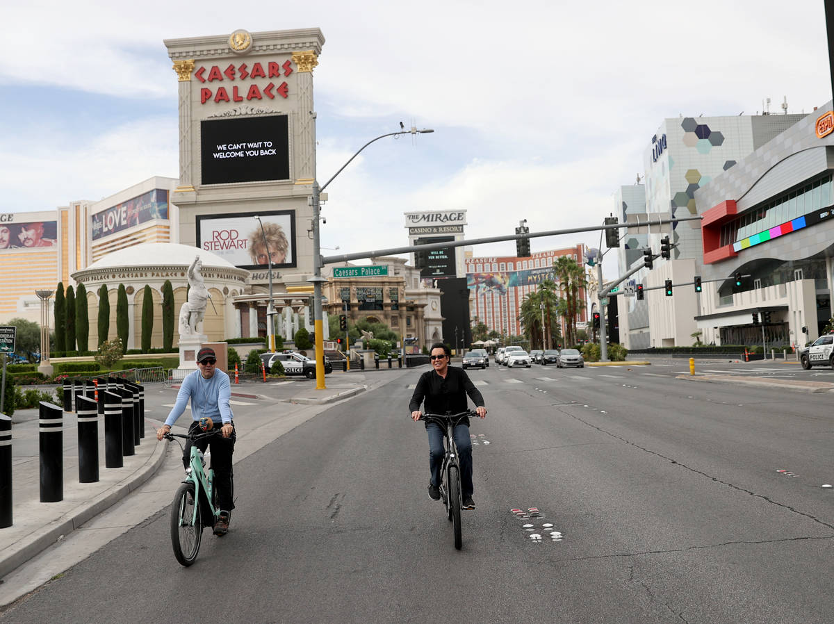 Mr. Las Vegas Wayne Newton, right, rides a bicycle on the Strip in Las Vegas with Las Vegas Rev ...
