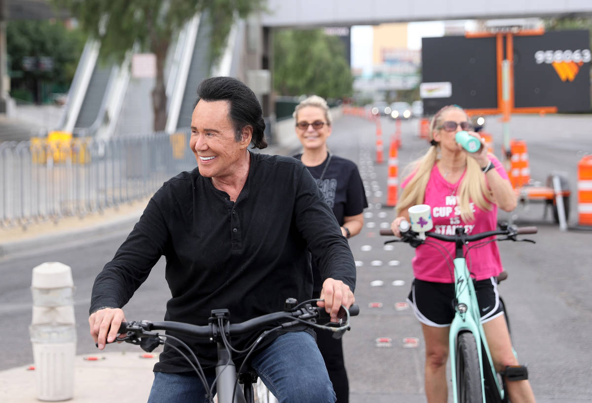 Mr. Las Vegas Wayne Newton, left, rides a bicycle on the Strip in Las Vegas with wife Kathleen ...