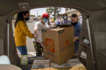 China Mama Restaurant's Ching Margos, left, and Bing Chou grab another large box of meals with ...