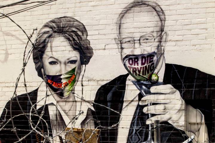 Mayor Carolyn Goodman and husband Oscar are portrayed in a mural now wearing face masks along a ...