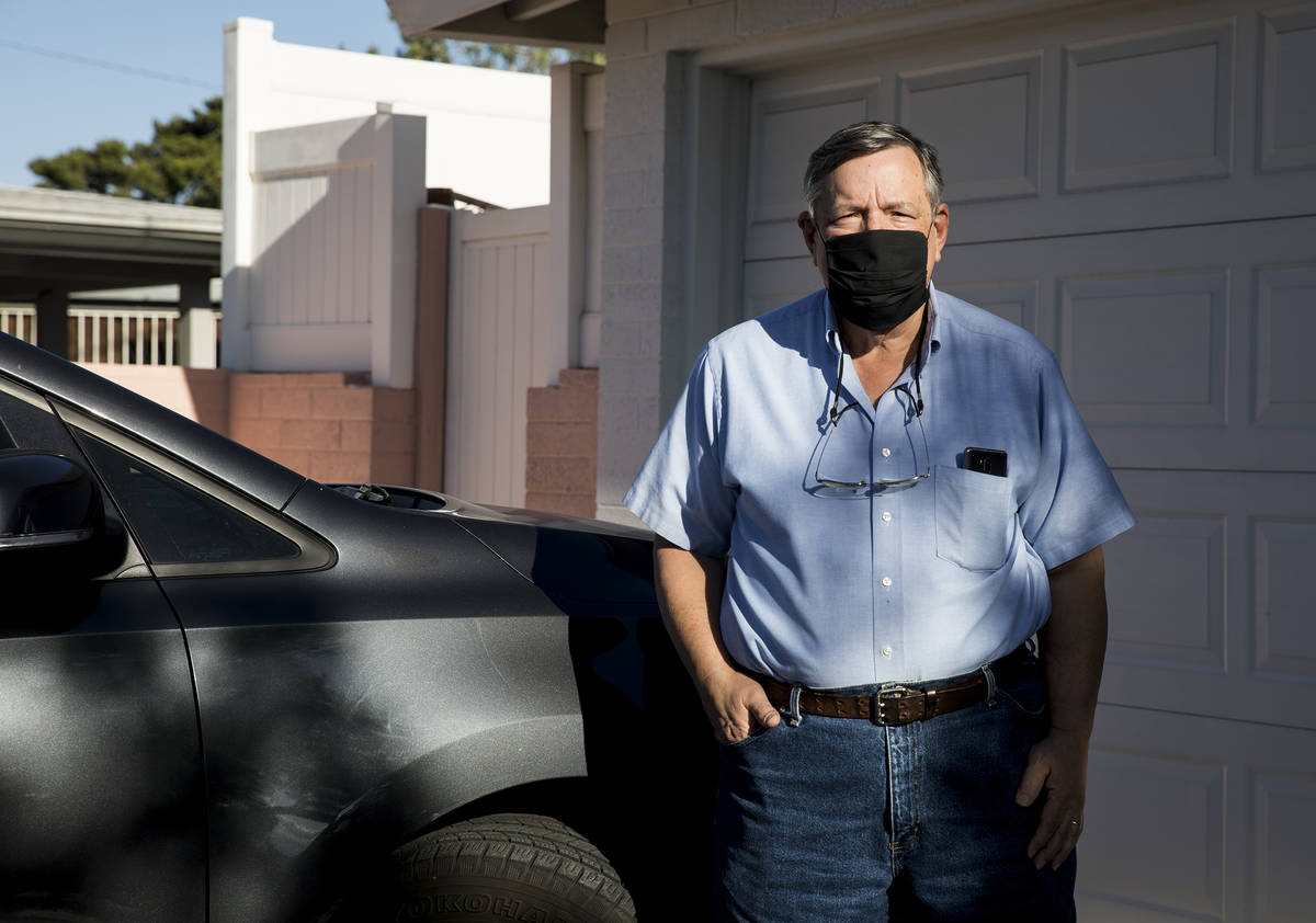 David Shapin, normally a full-time Uber and Lyft driver, next to his car at his home in Las Veg ...
