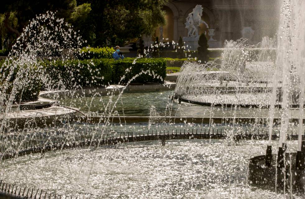 A maintenance worker looks to the main Caesars Palace fountain area now back in operation on Mo ...