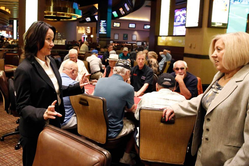 Tracy Mendiola, left, talks to Kathy Raymond, right, both poker rooms managers at the Station C ...