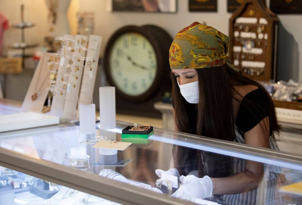 Brittany Bailey wears a mask and gloves during her first shift back after coronavirus-caused no ...