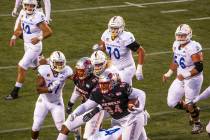 UNLV Rebels defensive lineman Kolo Uasike (94) runs back a game-winning interception late versu ...