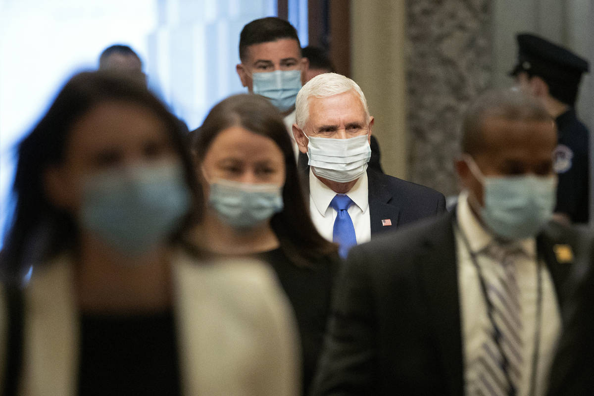 Vice President Mike Pence wears a face mask to protect against the spread of the new coronaviru ...