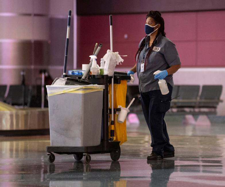 Cleaning staff work in the baggage claim area at McCarran International Airport on Wednesday, M ...