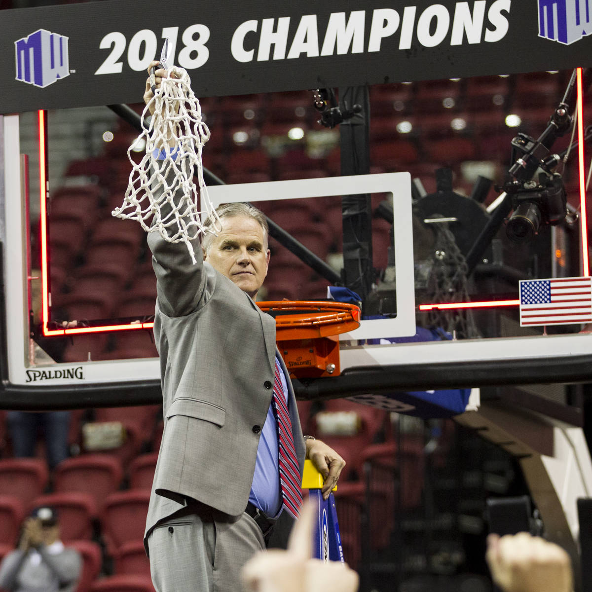 San Diego State Aztecs head coach Brian Dutcher after cutting down the net following a win agai ...