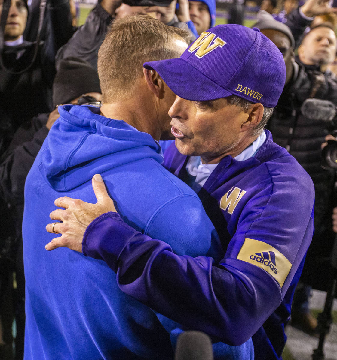 Boise State Broncos head coach Bryan Harsin, left, embraces Washington Huskies head coach Chris ...