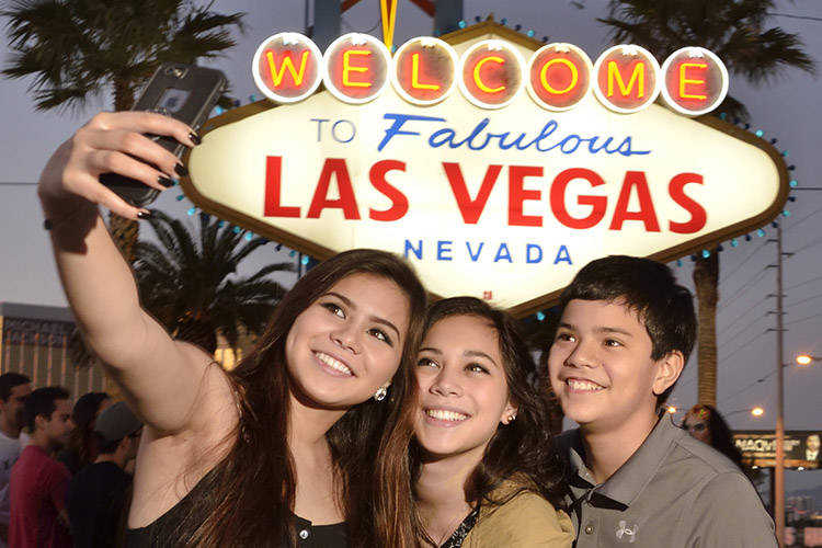 Chiara Atienza, from Quad Cities, Iowa, left, poses with her siblings, Catia, center, and Caide ...