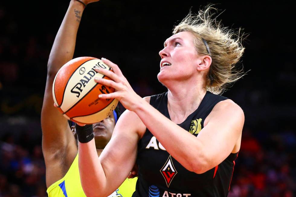 Las Vegas Aces' Carolyn Swords goes to the basket against Dallas Wings' Kaela Davis during the ...