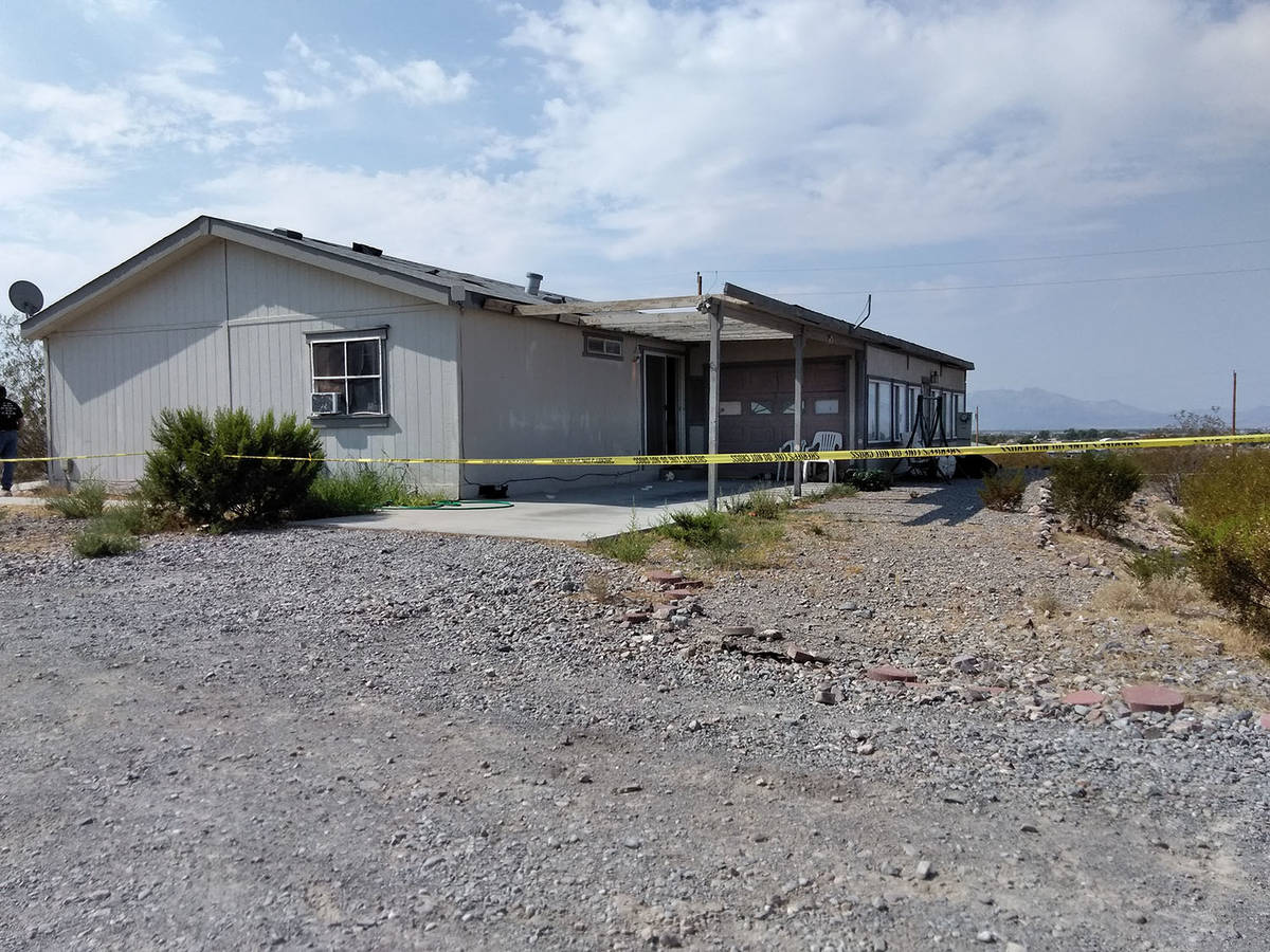 Yellow crime scene tape surrounds the property where authorities were investigating the death o ...