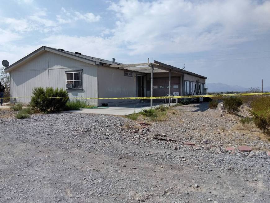 Yellow crime scene tape surrounds the property where authorities were investigating the death o ...