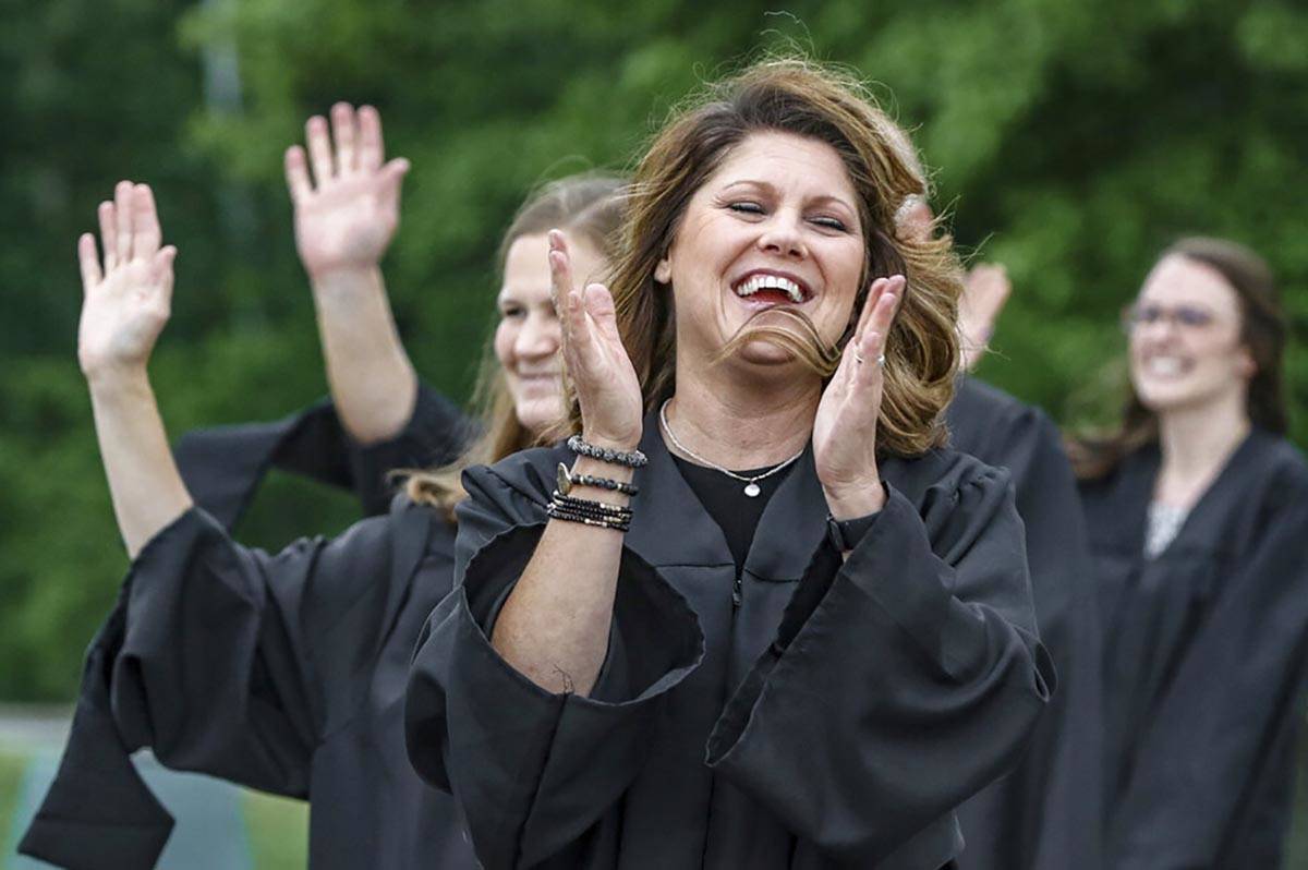 Daviess County High School teacher Krystal Phelps forms a line with fellow teachers, congratula ...