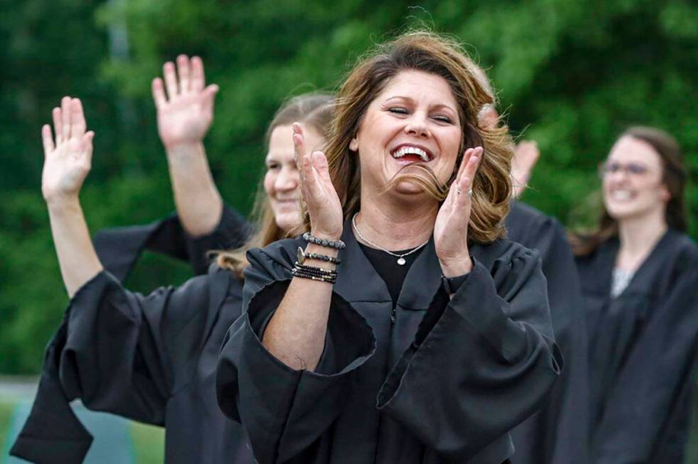 Daviess County High School teacher Krystal Phelps forms a line with fellow teachers, congratula ...