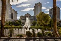 Cyclists pause to view the main Caesars Palace fountain area now back in operation on Monday, M ...