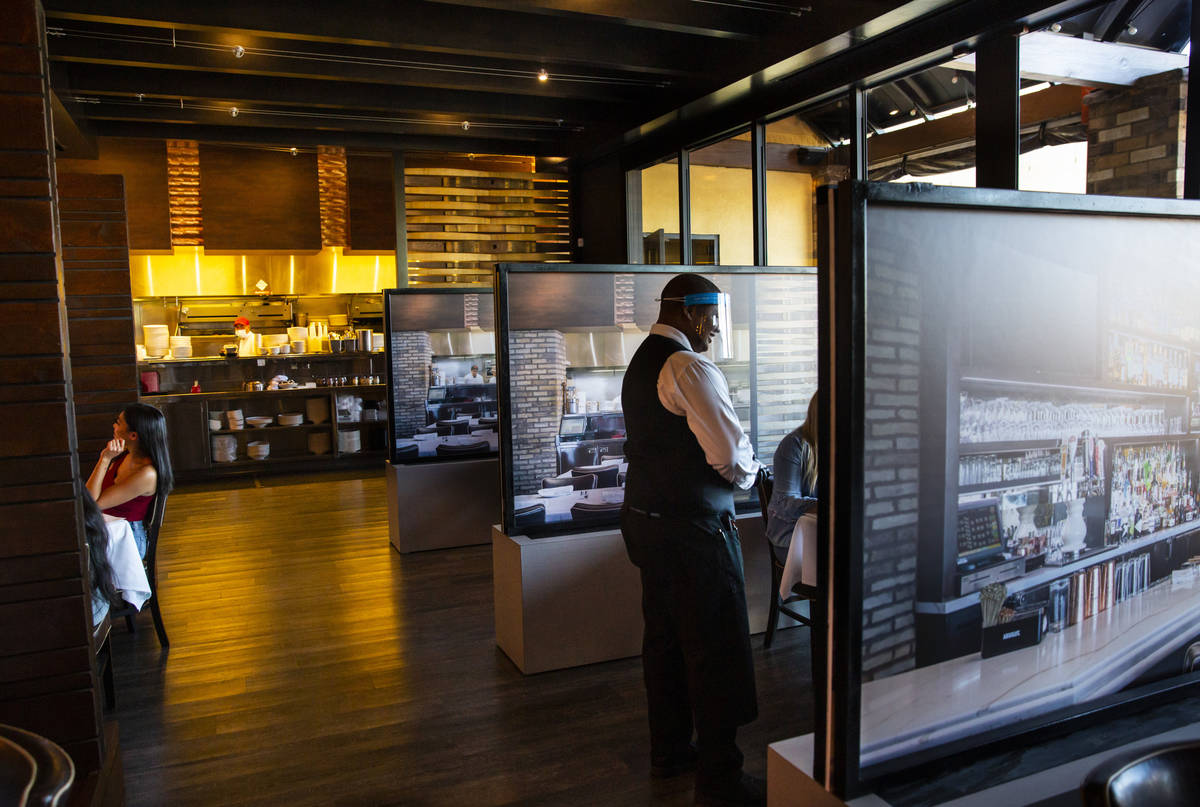 Donald Bailey wears a face shield while serving diners at Nora's Italian Cuisine in Las Vegas o ...