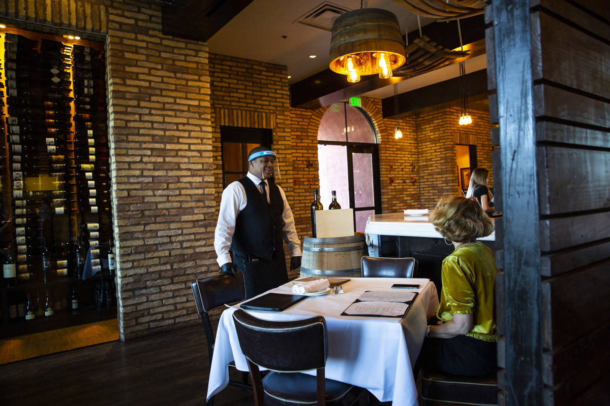 Donald Bailey wears a face shield while serving diners at Nora's Italian Cuisine in Las Vegas o ...