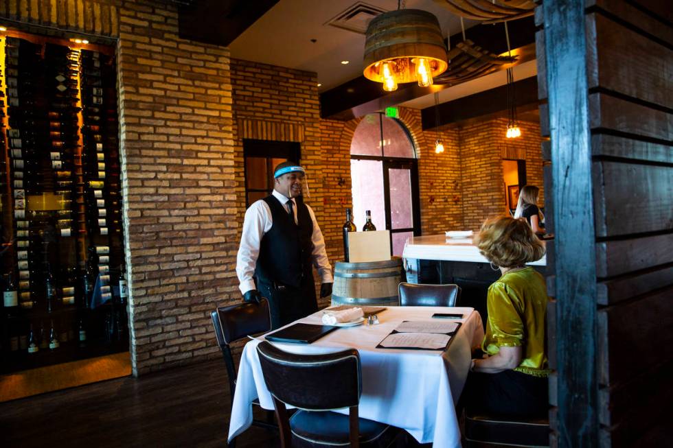 Donald Bailey wears a face shield while serving diners at Nora's Italian Cuisine in Las Vegas o ...