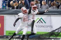 UNLV wide receiver Mekhi Stevenson (2) celebrates with teammate Jacob Gasser (82) after making ...